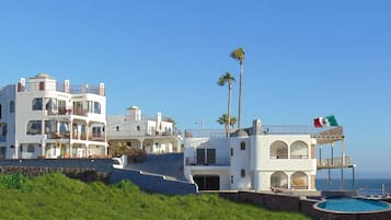 Enjoy stunning ocean views from the spacious balconies and terraces of this coastal retreat, which features a refreshing pool and lush surroundings.