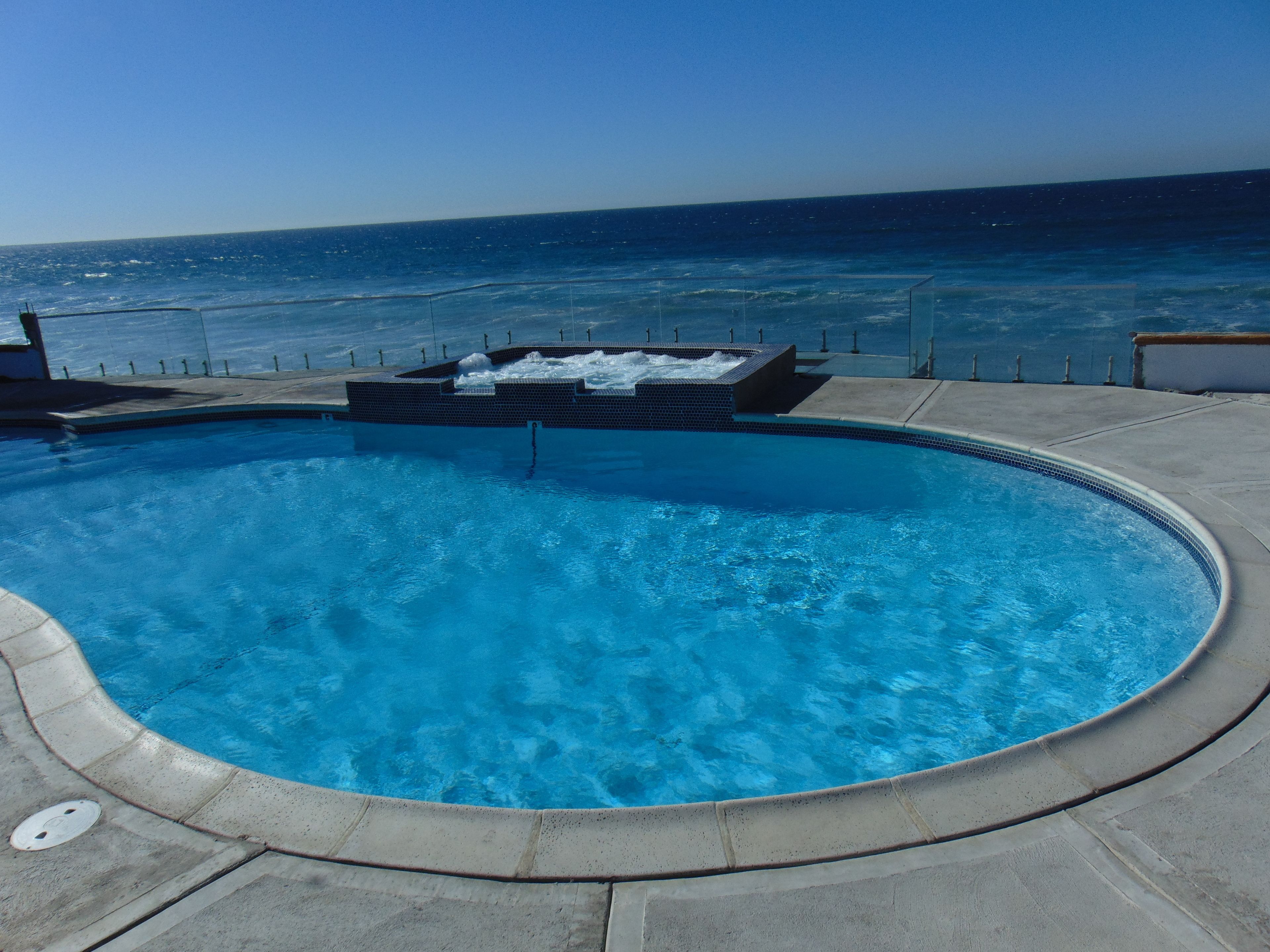 A pool with a view of the ocean.
