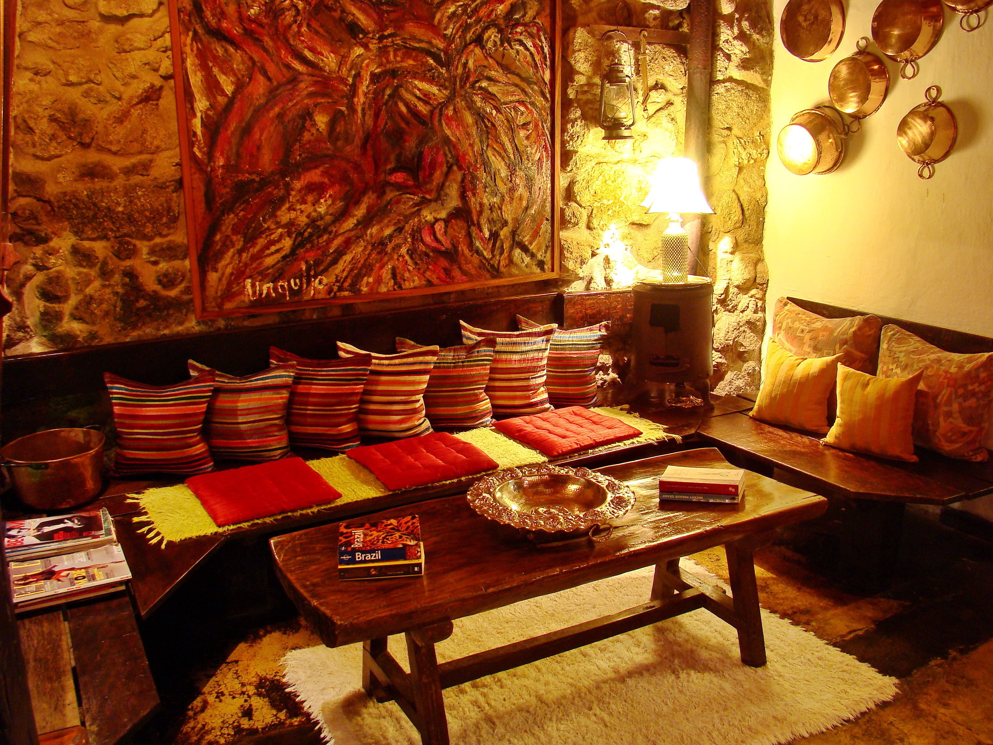 A cozy living room with a sofa, a coffee table, and a fireplace.
