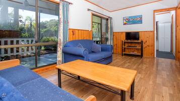 Cottage Cabin - 1 Queen, 1 Bunk and 1 Single | Living area | TV