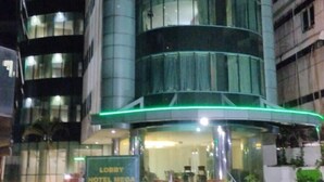 A hotel with a modern design, featuring a curved facade and a prominent entrance. - Hotel Mega Cikini (Jakarta)