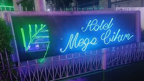 A neon sign for 'Hotel Mese Citar' with a geometric design. - Hotel Mega Cikini (Jakarta)