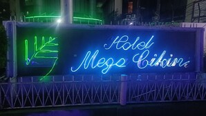 A neon sign for 'Hotel Megas Bikinis' with a simple geometric design. - Hotel Mega Cikini (Jakarta)