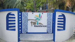 A gated entrance with a sign reading "Palm Residence." - Palm Residence (Rasdhoo)