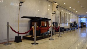 A modern hotel lobby with a traditional Japanese tea ceremony setup, including a tea cart and a lantern. - Asakusa Central Hotel (Tokyo)