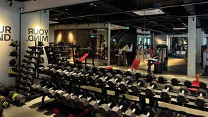 A gym with various exercise equipment, including dumbbells and weight machines. - The Smith House (Langkawi)