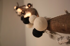 A close-up of a string of decorative lights with spherical ornaments, attached to a wooden structure. - Jing Shan (Tainan)
