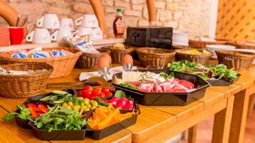 A buffet table with various food items and baskets.