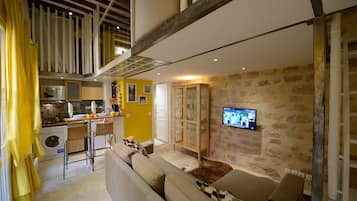 A compact living space with a kitchen, dining area, and seating area.