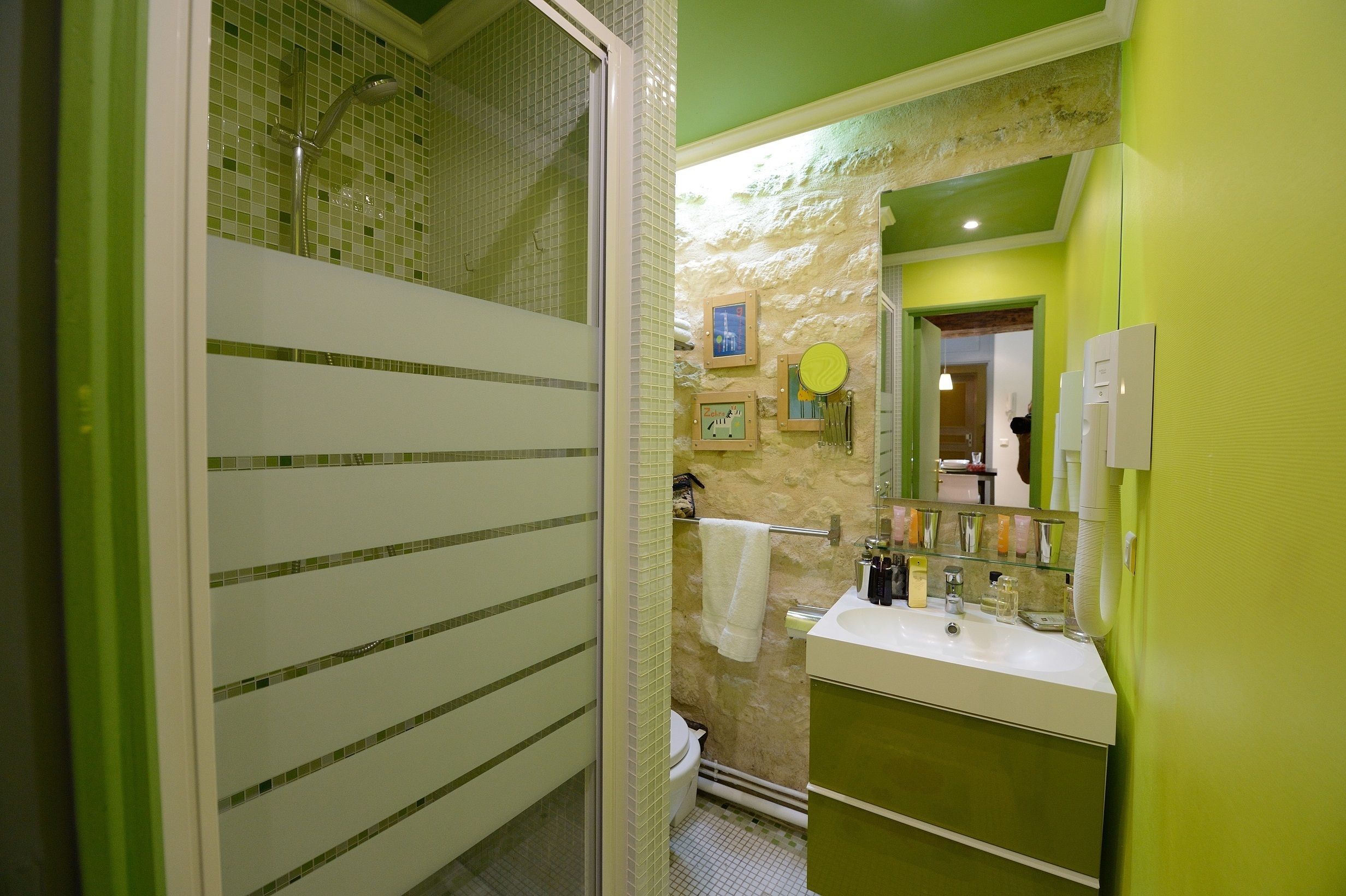 A bathroom with a shower, toilet, and sink.