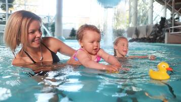 Swimmers can enjoy the pool surrounded by large windows and a soothing water fountain.