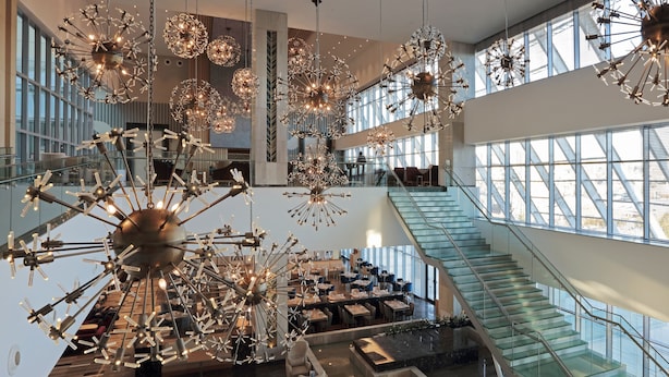 A spacious lobby with multiple seating areas, a grand staircase, and large windows allowing natural light. - The Ankara Hotel (Ankara)