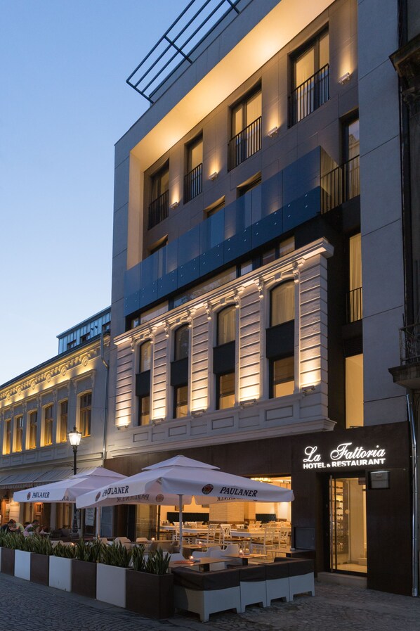 A hotel with outdoor seating and a sign reading "La Fattoria HOTEL & RESTAURANT". - Old Town Boutique Hotel (Bucharest)