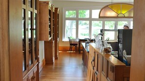A wooden interior with a kitchen area, including cabinets and a counter. - Holman's Heritage Suites (Summerside)