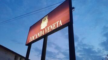 A sign with the text "LOCANDA VENETA" and a logo.