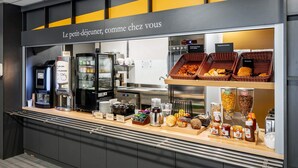 A breakfast buffet with various food items and a coffee station. - B&B HOTEL Castres Centre Gambetta (Castres)