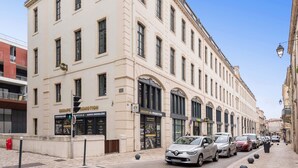 A multi-story building with a beige facade, large windows, and a sign for 'Groupe Promotion'. - B&B HOTEL Castres Centre Gambetta (Castres)