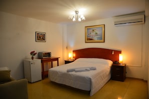 Premium tweepersoonskamer | Een kluis op de kamer, een bureau, beddengoed