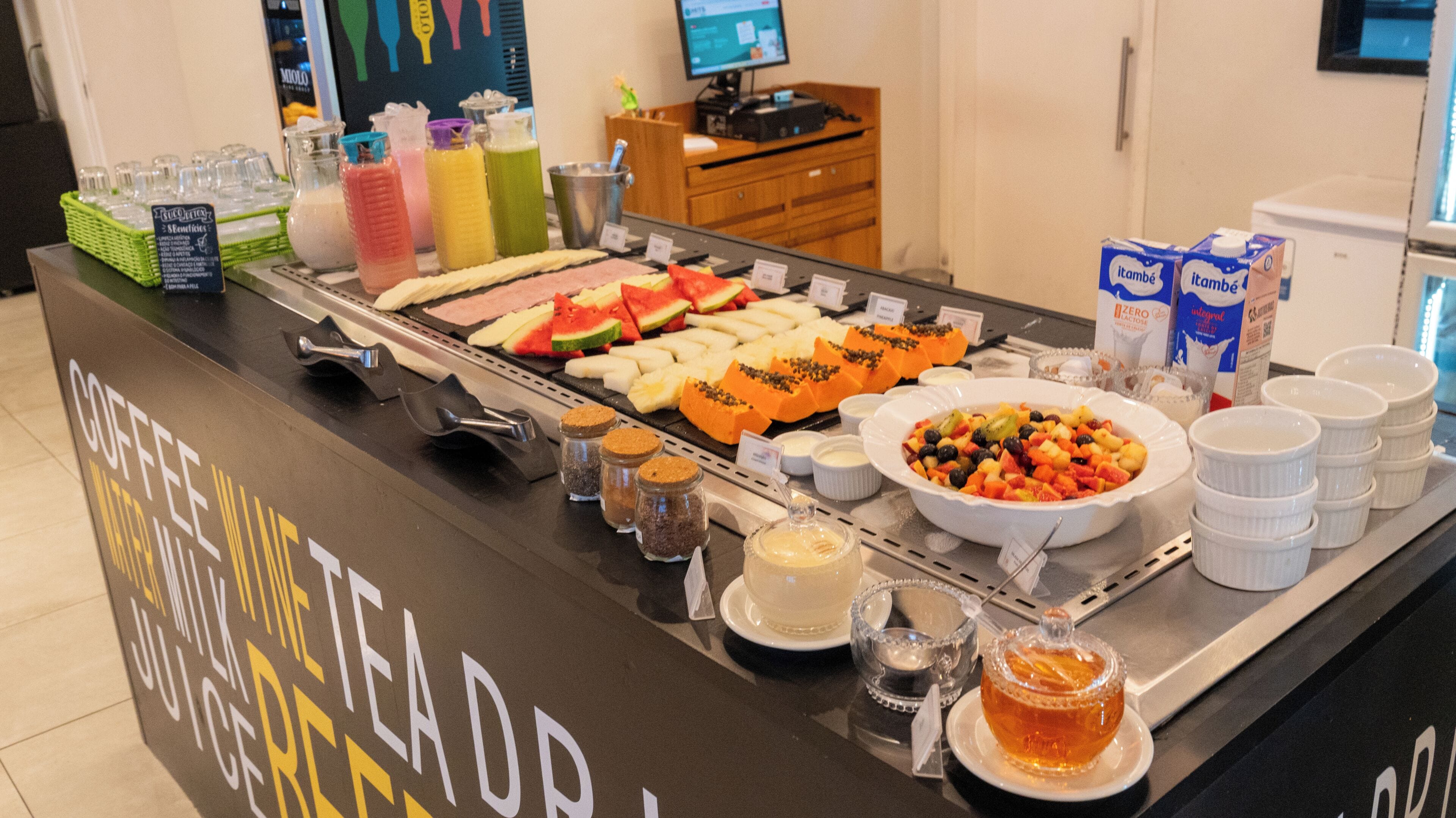 A buffet with various food items and beverages.