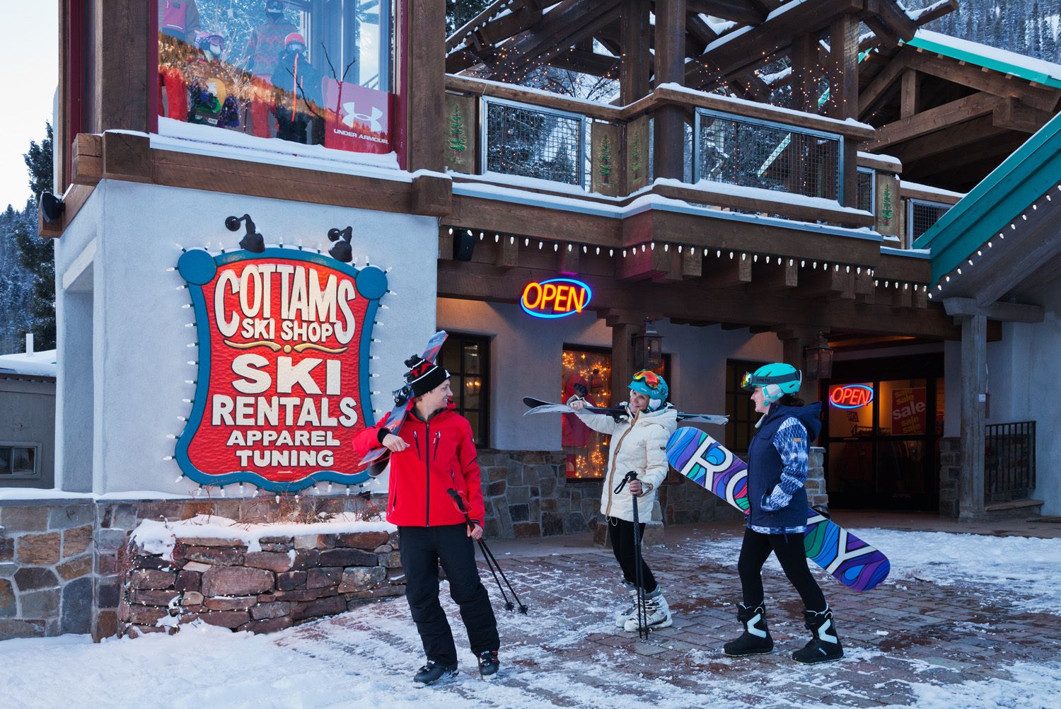 A ski shop with a sign advertising ski rentals and apparel tuning.