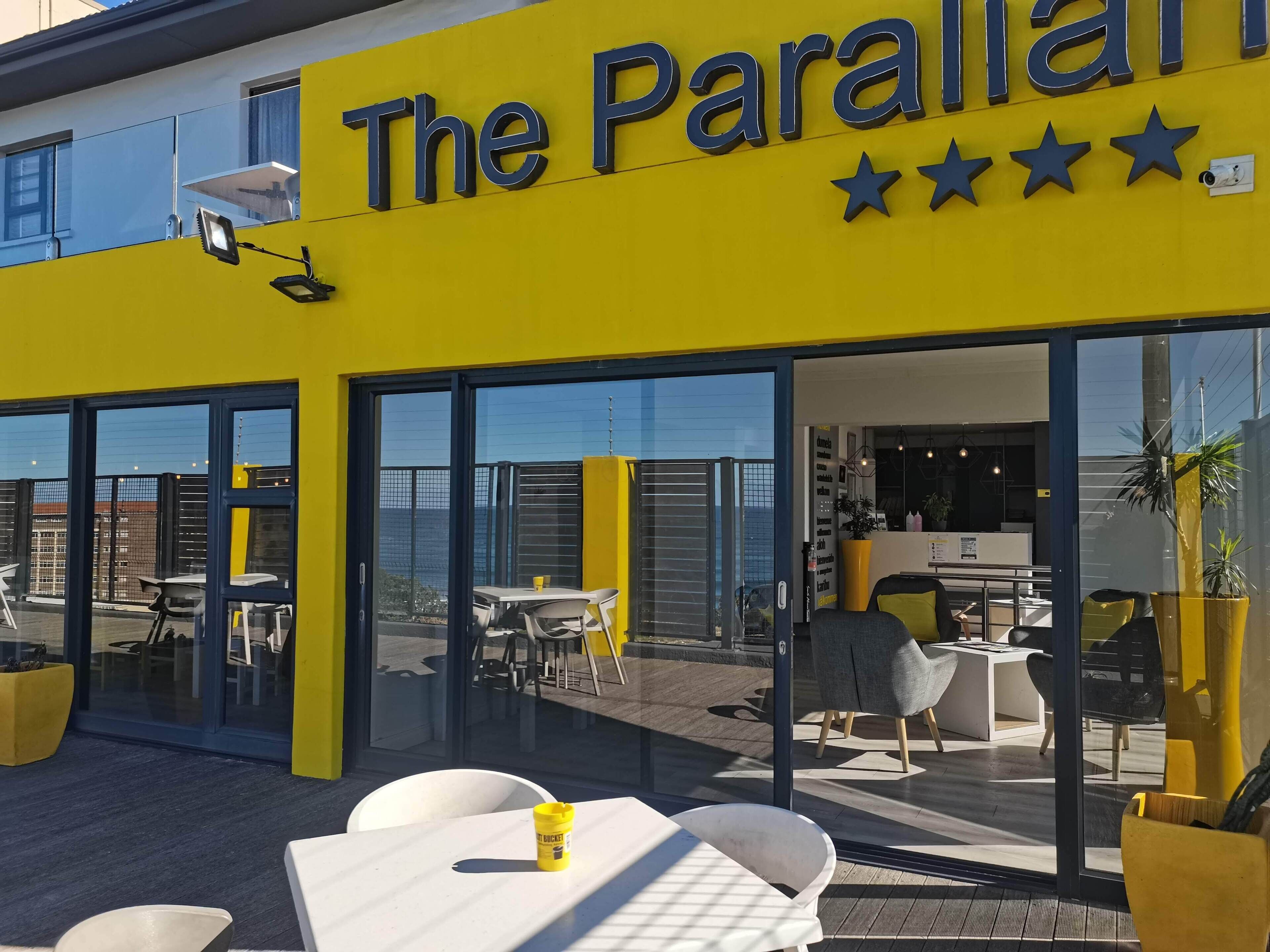 A yellow building with a sign reading "The Parallal" and three stars.