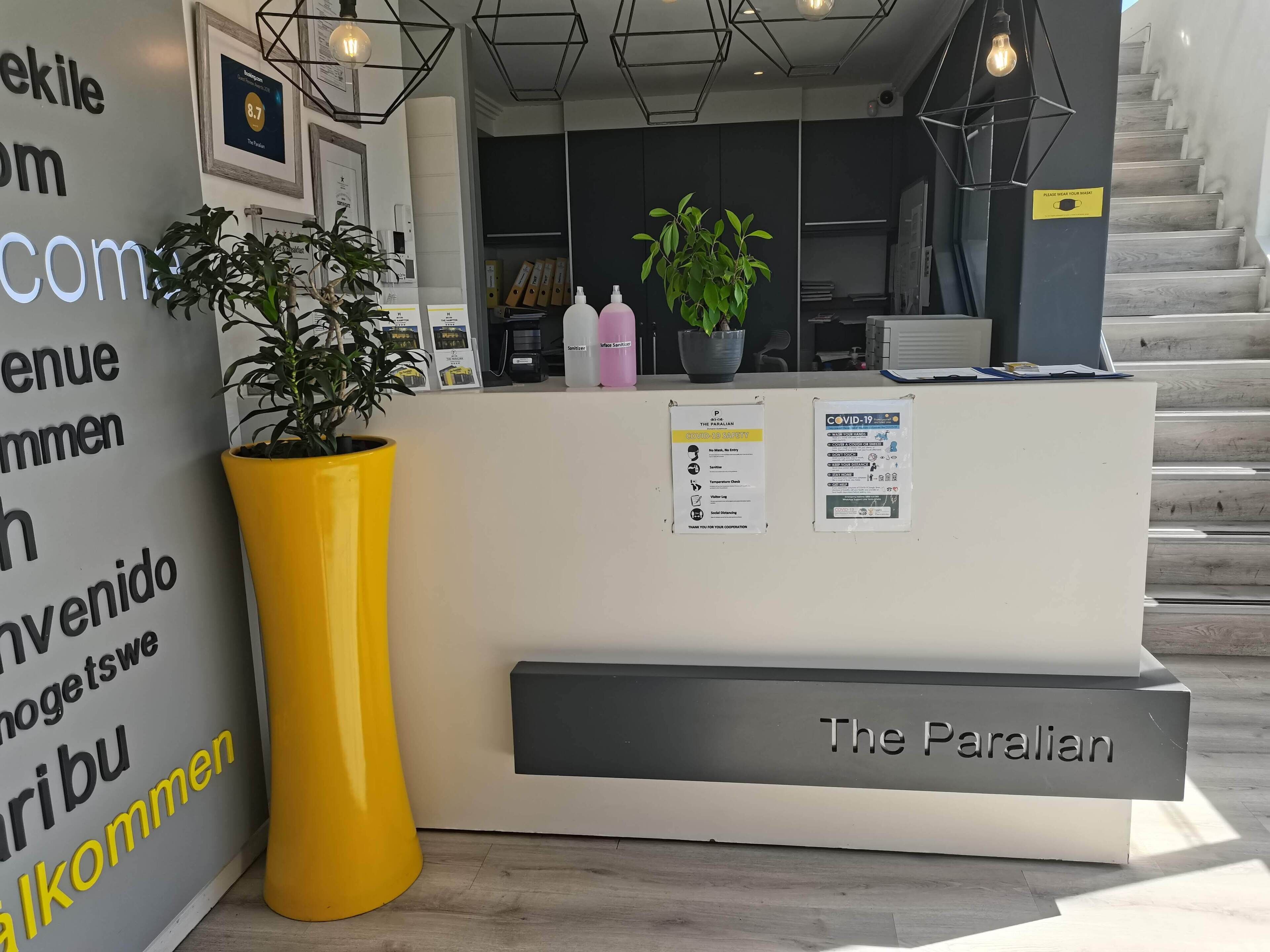 A reception desk with a sign reading "The Paralian."