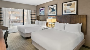 A hotel room with two beds, a desk, and a chair. There are three framed pictures on the wall. - Sonesta Hotel Baltimore Inner Harbor (Baltimore)