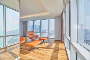 A modern office space with large windows, wooden flooring, and orange chairs. - Kolon Seacloud Hotel (Busan)
