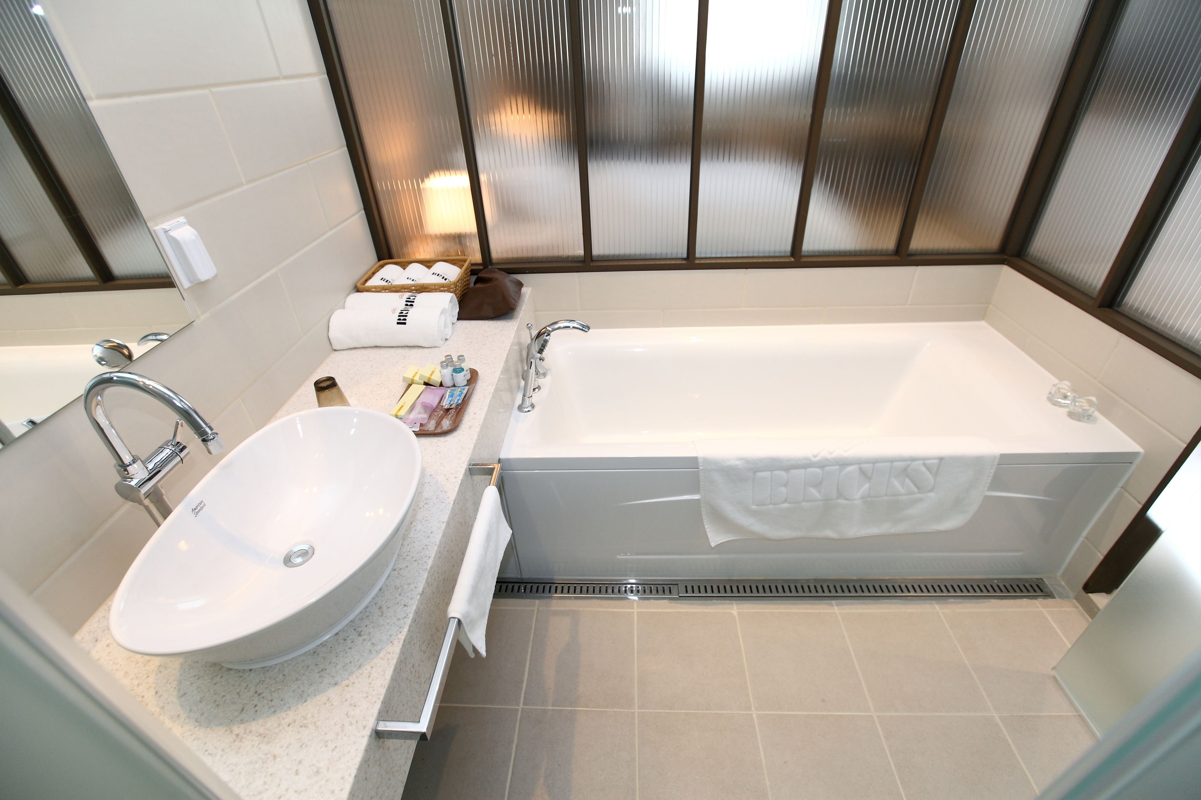deluxe room | bathroom | designer toiletries, hair dryer, dressing gowns, slippers
