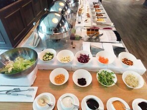 A buffet setup with various food items and utensils. - All-Ur Boutique Motel - Xin-Jhung Branch (New Taipei City)