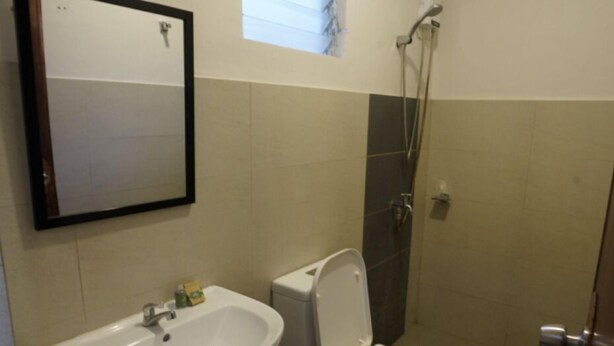 A small bathroom with a sink, toilet, and shower. - Anaya Beach Resort (Bantayan)