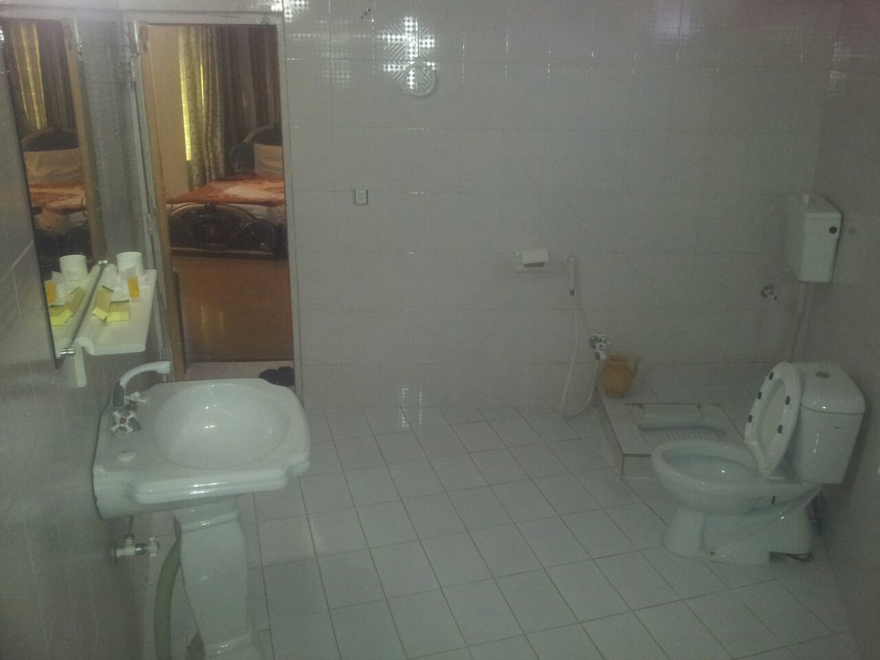 A bathroom with a sink, toilet, and shower area.