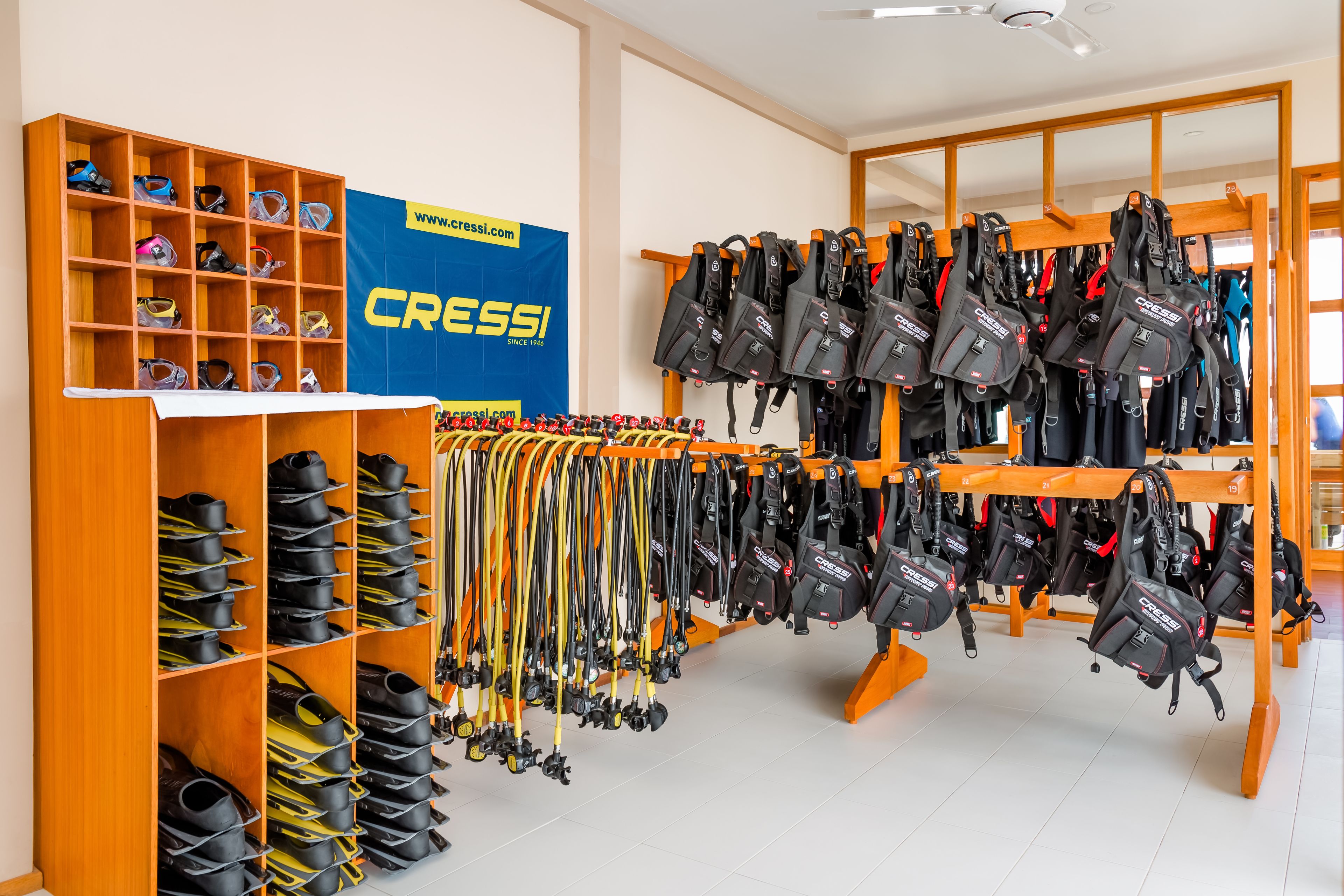 A shoe and backpack display area with multiple shelves and racks.