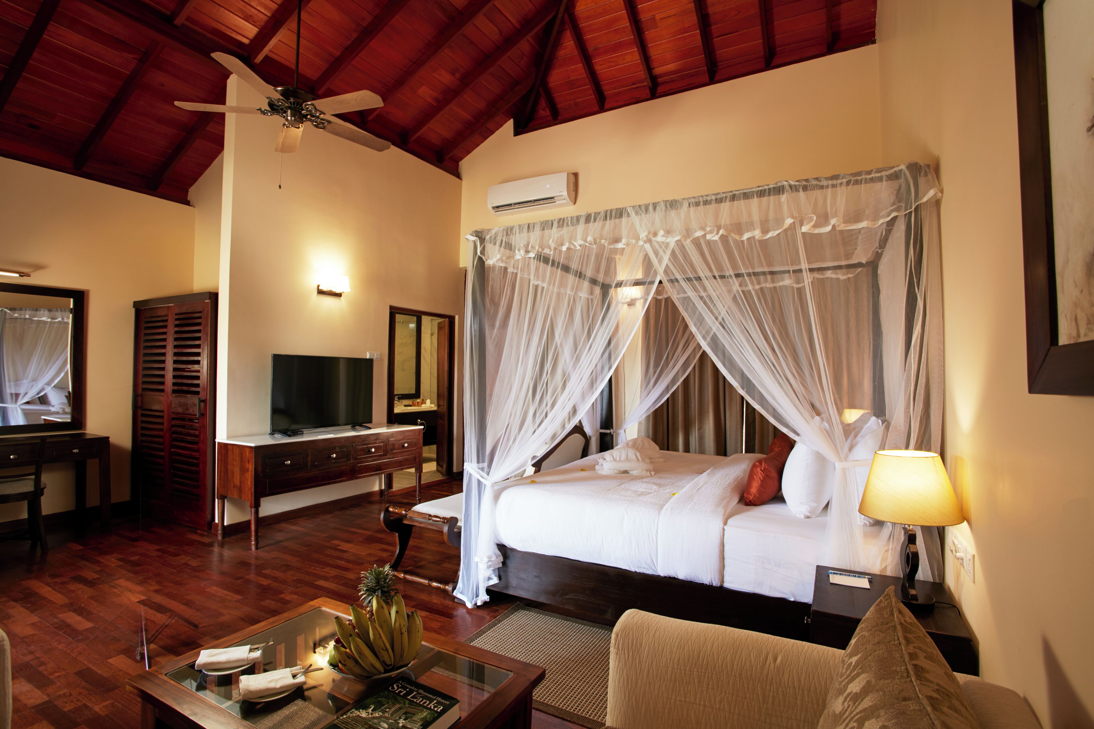 Quarto luxo, 1 cama King | Área de estar | TV de tela plana 50 polegadas com canais via satélite, TV