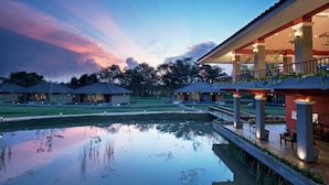 A resort with a pool, outdoor seating, and a sunset view. - Seerock The King's Domain (Avudangawa)