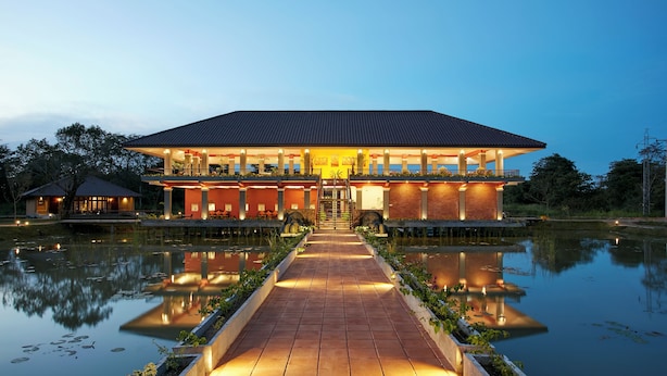 A large, modern hotel with a central courtyard and a reflective water feature. - Seerock The King's Domain (Avudangawa)