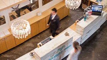 A reception desk with a sign reading "ISTANBUL MEDICAL TERMAL" and a large chandelier above it.