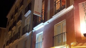 A building with a sign reading "Hostal" and a balcony with a railing. - Hostal riMboMbin (Burgos)