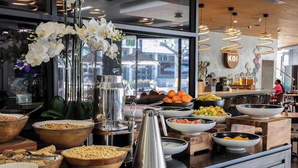 A buffet setup with various food items and a coffee station.