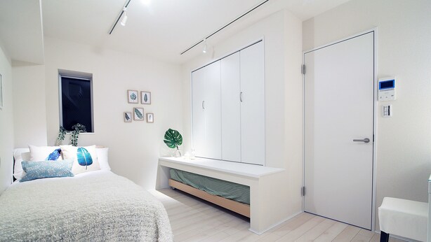 A bedroom with a bed, bedside table, wardrobe, and a small window. - The Sorapia Tokyo (Tokyo)