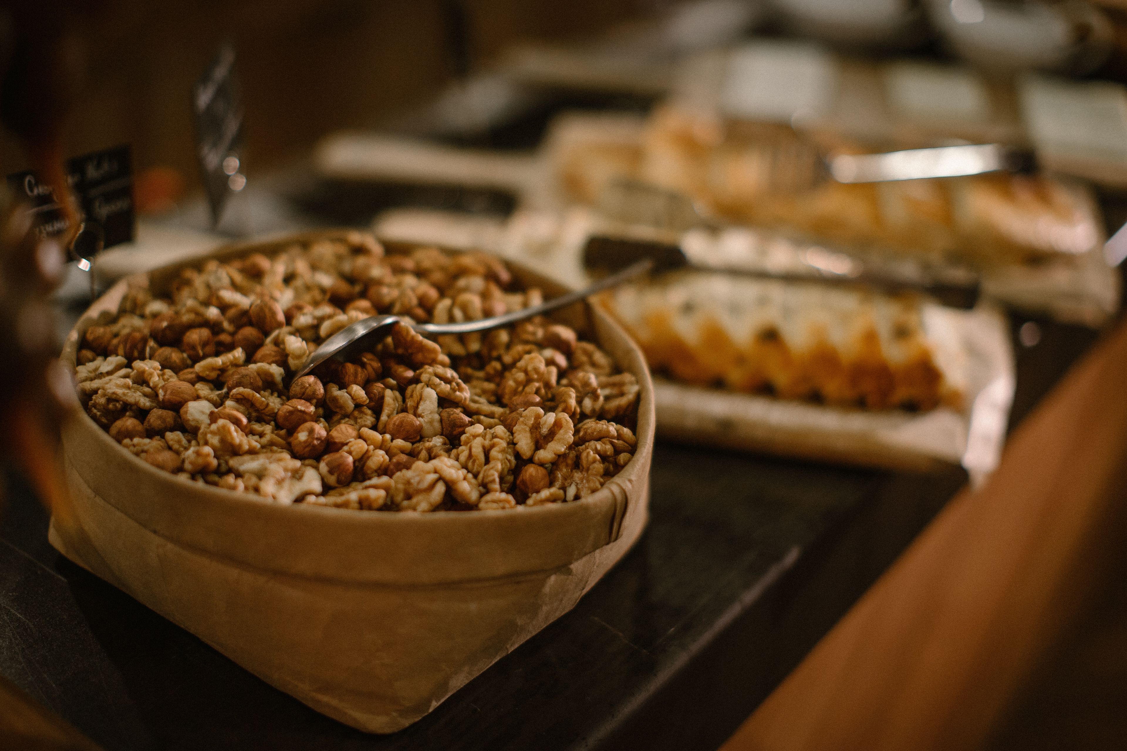 A buffet with various dishes, including a bowl of nuts and a tray of pastries.