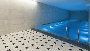 A swimming pool with tiled walls and a tiled floor, equipped with metal handrails. - Shota@Rustaveli Boutique hotel (Tbilisi)