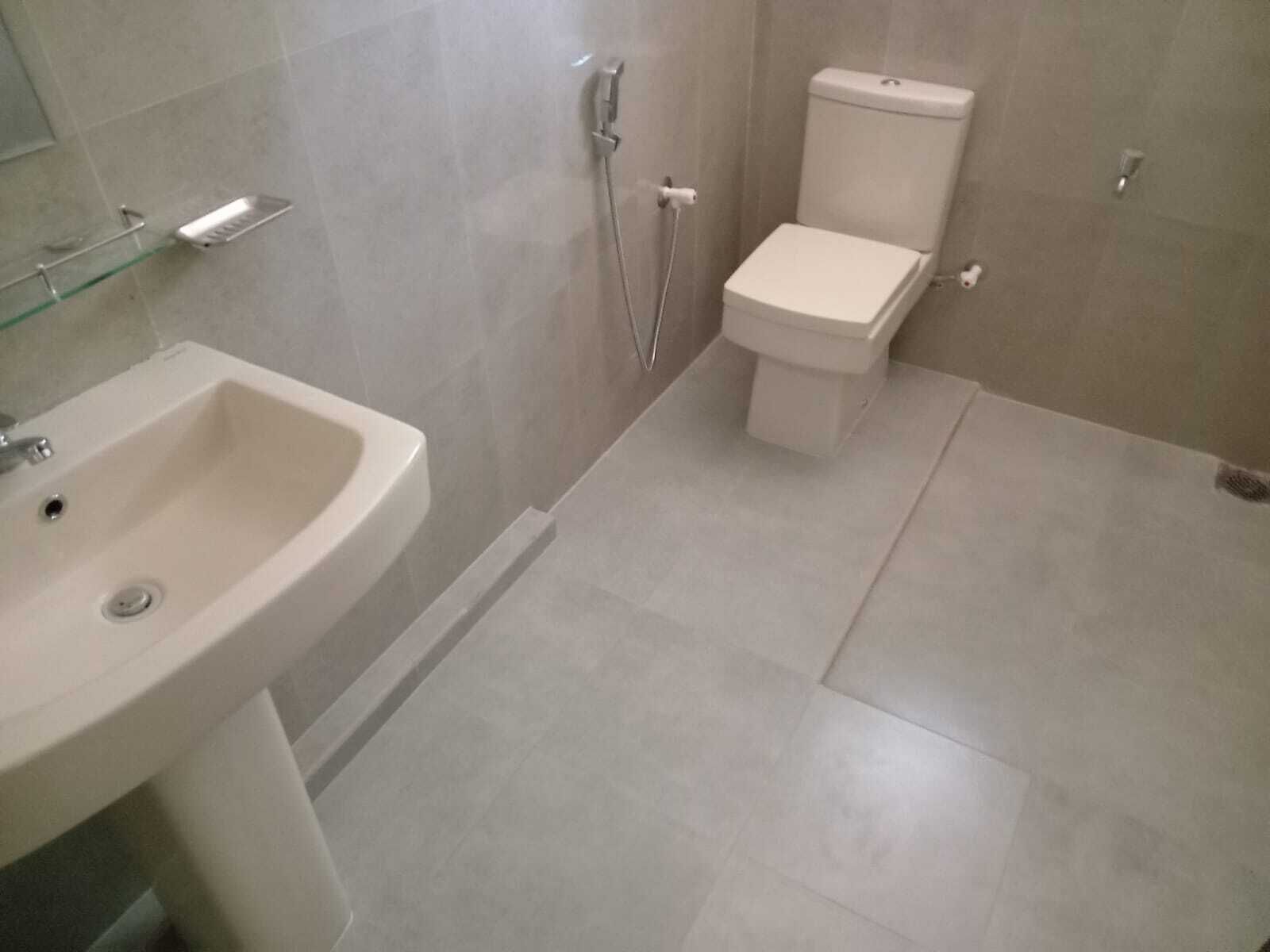 A bathroom with a sink, toilet, and shower.