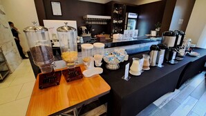 A breakfast bar with various food dispensers, coffee machines, and a minibar area. - Hotel Diego de Almagro Osorno (Osorno)