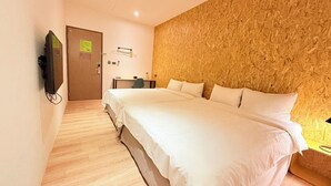 A hotel room with a large bed, a desk, a television, and a wooden accent wall. - Let’s Hostel (Kaohsiung)