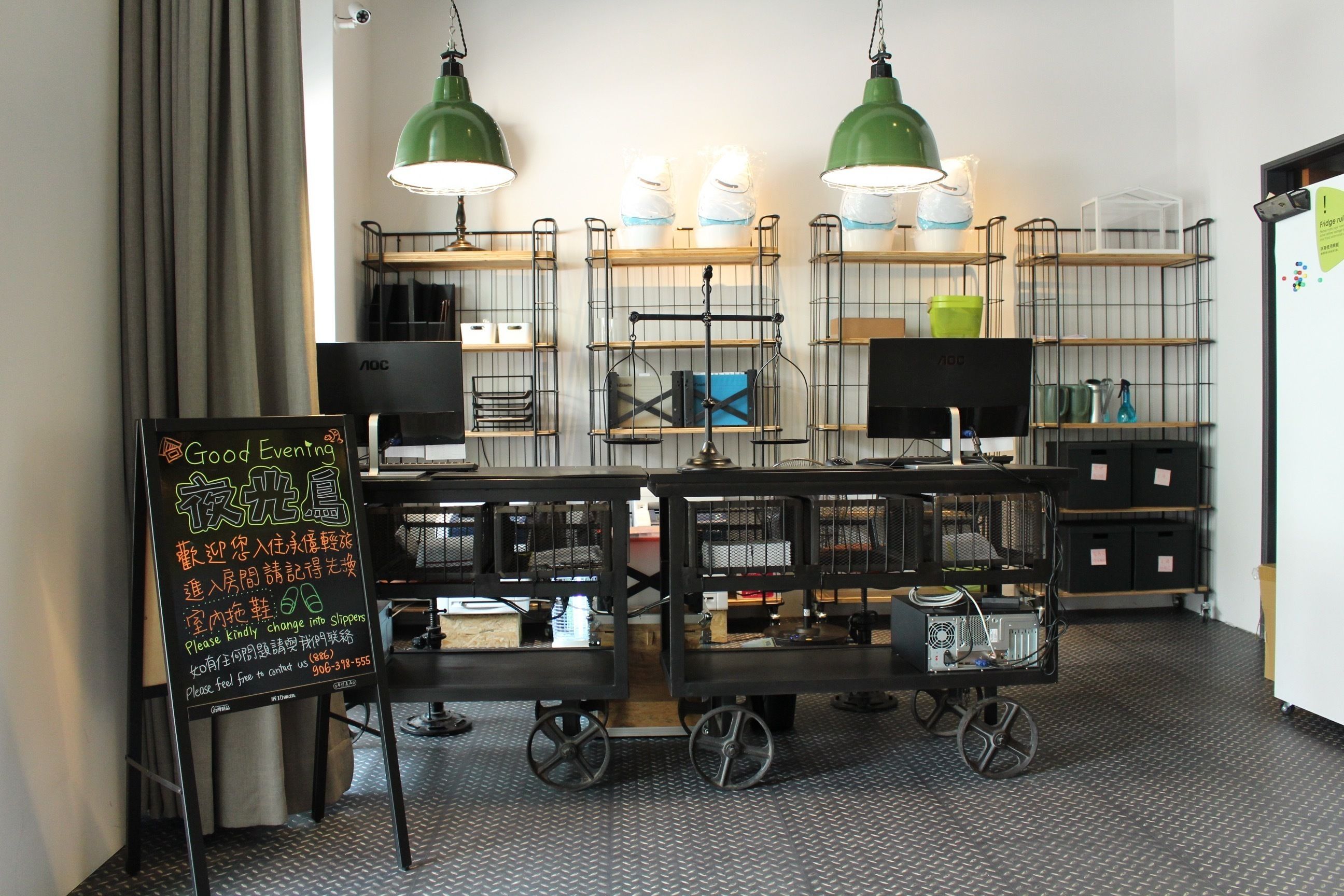 Un interior de restaurante con estanterías metálicas, un letrero en la pizarra y un carrito con una máquina de café.
