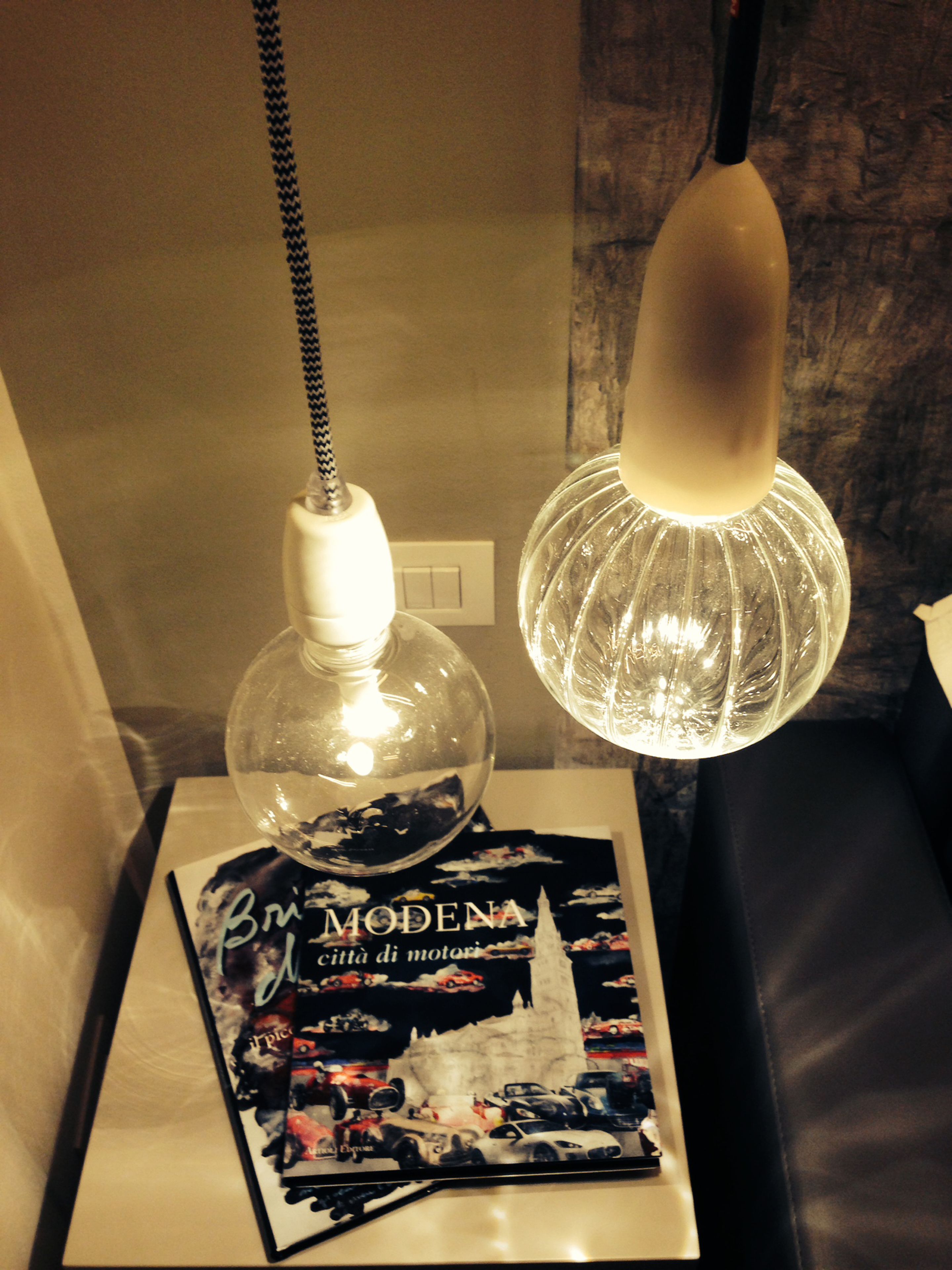 A table with a lamp and a brochure.