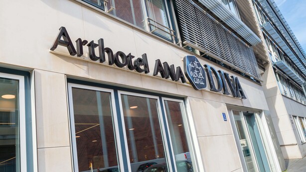 The exterior of Arthotel ANA with large windows and a modern facade. - elaya hotel munich city,  Trademark Collection by Wyndham (Munich)