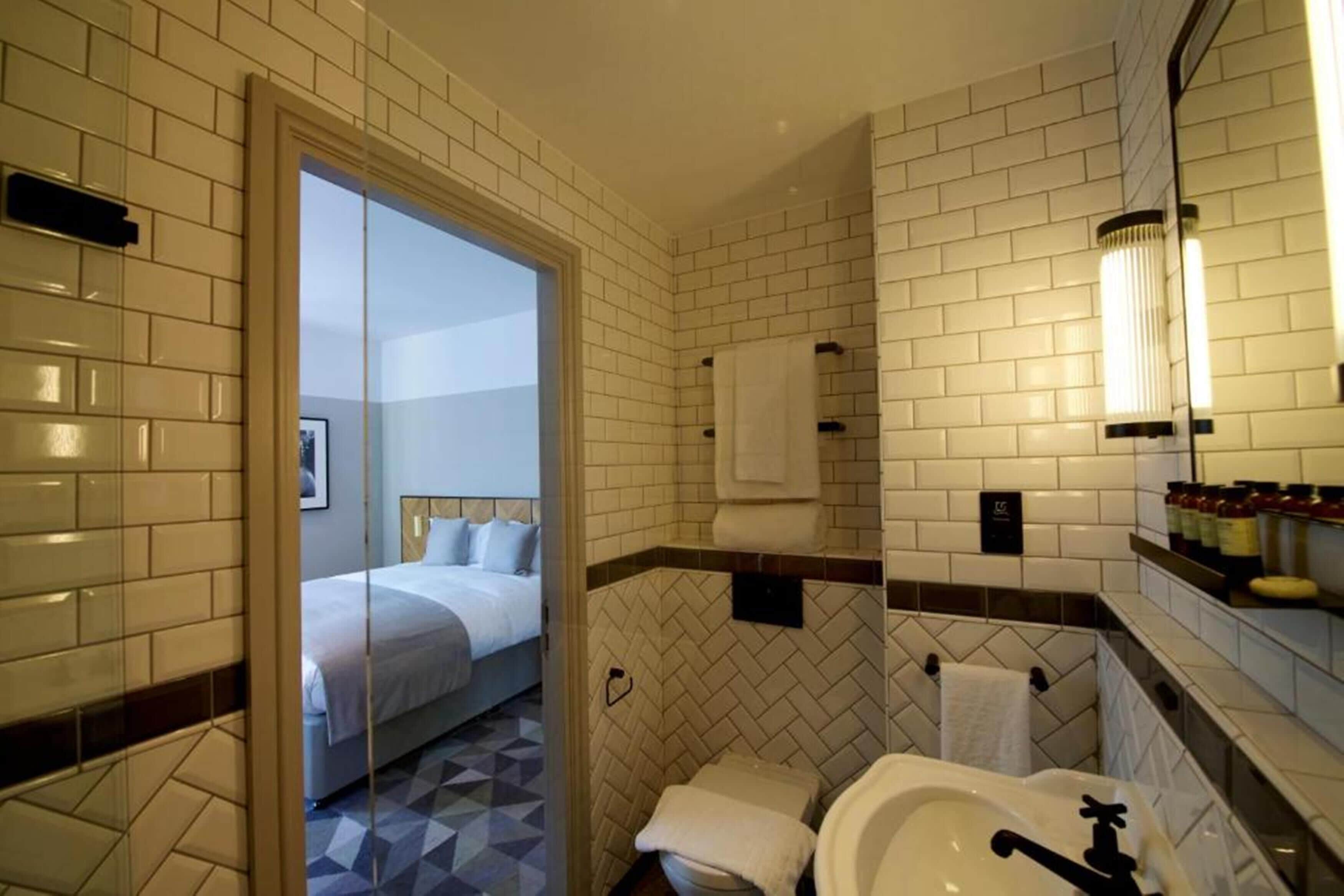 deluxe double room | bathroom | shower, rainfall showerhead, hair dryer, towels