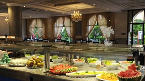 A buffet with various food items and a chandelier. - Ennakhil Marrakech Hotel & SPA (Marrakech)